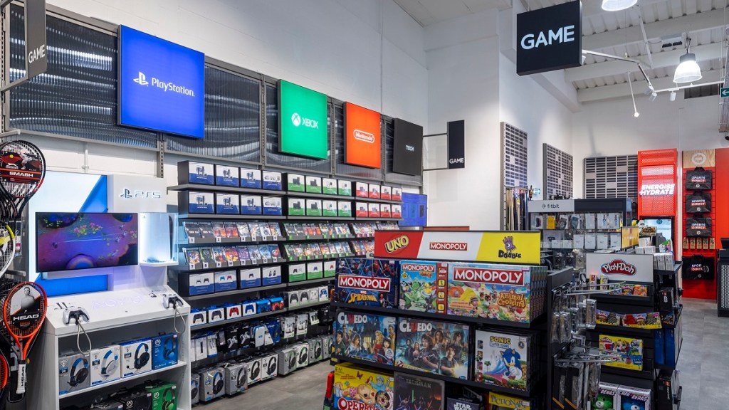 Photo of the inside of a GAME store in the UK, showing the PlayStation, Xbox, and Nintendo sections.