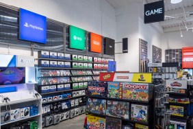 Photo of the inside of a GAME store in the UK, showing the PlayStation, Xbox, and Nintendo sections.
